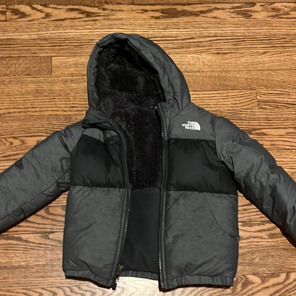 dark grey and black kids north face jacket